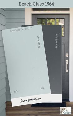 the front door of a house with two different shades of gray and white on it