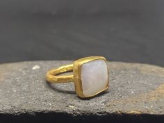 ARTSMYRNA METAL: 925k Silver GEM: Pearl ( lab created ) Diameter Stone Size: 12x12 COATING: 24k gold over (We can made a special type of coating for your personal preference ) MATERIEL : 925K Sterling Silver ( Some of my items vermeil gold over silver for looks rich . But i can finish in silver too ) RING SIZE: 6 (your desired size is made) GEM FEATURES AND BENEFITS Features of Pearl Stone * The origin of the cultured pearls, which is obtained by putting a piece of mother-of-pearl on the oysters Unique Stackable Opal Ring As Gift, Elegant Handmade Everyday Moonstone Ring, Elegant Everyday Handmade Moonstone Ring, Elegant Hand Forged Moonstone Ring Gift, Minimalist Handmade Moonstone Ring For Anniversary, Hand Forged Fine Jewelry Rings As Gift, Handmade Opal Open Ring For Gift, Handmade Opal Open Ring Gift, Handmade Open Opal Ring For Gift