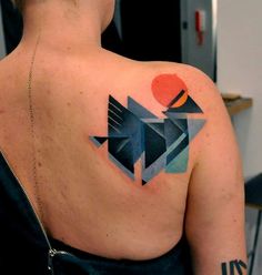 a woman with a geometric tattoo on her back