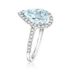 an aqua blue topaz ring with diamonds on the sides and a center stone in the middle