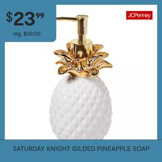 a white pineapple soap dispenser sitting on top of a counter