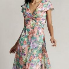 Product Details: This Floral-Printed Georgette Dress Pairs A V-Neckline And Draped Cap Sleeves With A Twist-Drape Bodice To Create A Full-Skirted Silhouette Straight Out Of A Dream. The Style Boasts A Versatile Fit That Flatters All Body Types. Lined. Concealed Back Zip. V-Neckline And Back Short Sleeves Twist Draped Bodice All Over Floral Print Motif Imported Dry Clean Color: Sunrise Floral Floral Print V-neck Dress For Wedding Guest, V-neck Floral Print Dress For Wedding Guest, Floral Print V-neck Cocktail Dress, Formal Floral Print Dress With Surplice Neckline, Floral Print V-neck Dresses For Wedding, V-neck Floral Print Dresses For Wedding, V-neck Floral Maxi Dress For Wedding Guest, Floral Print V-neck Wedding Dress, Purple V-neck Dress For Wedding Guest