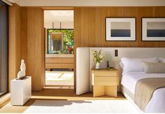 a bedroom with wood paneling and pictures on the wall