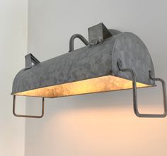 an industrial style light fixture hanging from the wall