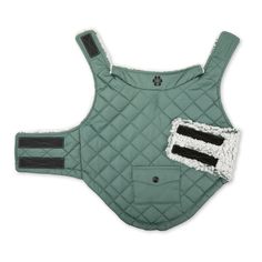 a green quilted vest with black and white patches