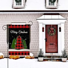 a house decorated for christmas with decorations on the front door