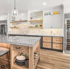 a large kitchen with an island in the middle and lots of counter space on one side