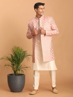 Vastramay Men's Pink Mirror Indo Western Sherwani with Kurta Pyjama Set Look impeccably stylish in this pink mirror work Sherwani set. Featuring a trendy Indo-Western design, the Sherwani boasts intricate mirror work and a mandarin collar, while the Kurta and Pyjama complement perfectly. Key Features Aqua blue mirror work design on Sherwani Mandarin collar, full sleeves on Sherwani, Kurta & Pyjama Cream colored Kurta and Pyjama Elasticated waistband with button closure on Pyjama Specifications S Pink Bandhgala With Chikankari Embroidery, Pink Bandhgala With Resham Embroidery For Eid, Traditional Pink Sherwani With Gota Work, Pink Straight Kurta Sherwani For Diwali, Pink Sherwani Straight Kurta For Diwali, Pink Straight Kurta Sherwani For Festivals, Diwali Pink Sherwani Straight Kurta, Pink Sherwani With Mirror Work For Designer Wear, Pink Bandhgala With Zari Work For Eid