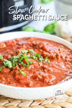 slow cooker spaghetti sauce in a white bowl on a wicker mat with text overlay