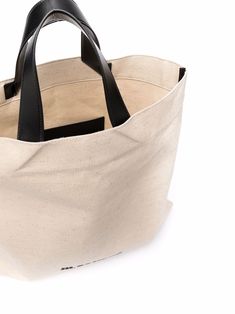 Light beige/black fabric/leather logo-print tote bag from JIL SANDER featuring logo print to the front, open top, two top handles, main compartment and internal slip pocket. | Jil Sander Logo-Print Tote Bag Leather Logo, Open Top, Jil Sander, Print Tote, Printed Tote Bags, Light Beige, Sanders, Black Fabric, Front Open