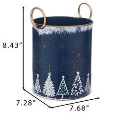 a blue tin with white trees painted on it and gold handles is shown in front of the measurements