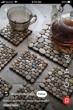 some rocks are arranged on the ground next to a tea pot