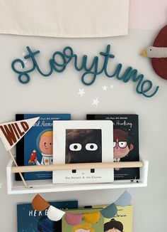 there is a book shelf with books on it and a sign that says storytime