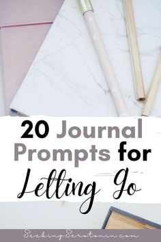 the words, 20 journal prompts for letting go on top of a marble table