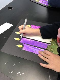 two children are making art with paper and glue