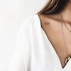 a woman with a small tattoo on her neck