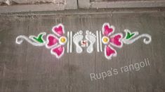 the name rupa's ranggoli written in white and pink on a concrete surface