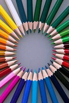 many colored pencils arranged in a circle