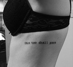 this too shall pass tattoo on the side of a woman's stomach is shown in black and white