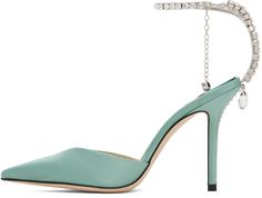 Satin heels in green. · Pointed toe · Hook-eye ankle strap · Crystal-cut charm at heel · Logo patch at leather footbed · Covered stiletto heel · Suede sole · Heel: H4 in Supplier color: Smoke green/Crystal Elegant Green Heels With Single Toe Strap, Green Formal Heels With Single Toe Strap, Green Pointed Toe Heels With Heel Loop, Luxury Green Open Heel Heels, Luxury Green Suede Heels, Green Pointed Toe Luxury Heels, Jimmy Choo Green Heels, Luxury Green Pointed-toe Dress Shoes, Ivory Pumps