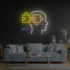 a living room with a couch, coffee table and neon puzzle pieces on the wall