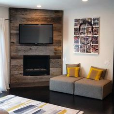 a living room with two couches and a flat screen tv mounted on the wall