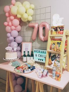 a table topped with lots of food and balloons