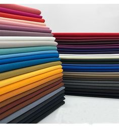 a stack of different colors of fabric