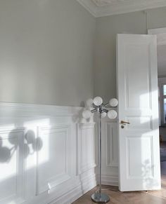 an empty room with white walls and wood flooring is pictured in this image from the doorway