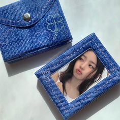 a blue wallet with a picture on the front and side, sitting next to it