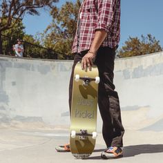 a man holding his skateboard at the top of a ramp in a skate park