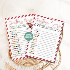 two christmas games are sitting on top of a table with red and white striped paper