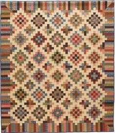 an antique quilt with multicolored squares on it