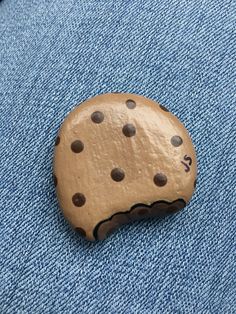 a rock with holes in it sitting on some blue jeans and the word la written on it