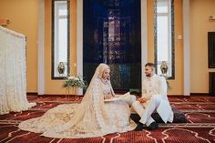 the bride and groom are sitting on the floor