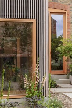 an outside view of a building with plants and flowers