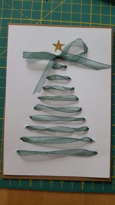 a christmas tree made out of ribbon on top of a piece of paper