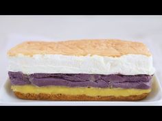 there is a sandwich on a plate with purple and white frosting