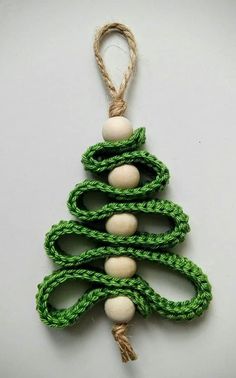 a green and white christmas tree ornament hanging from a string