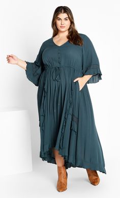 Drape your curves in the flowy Cadence Dress, offering a beautifully bohemian aesthetic. This dress can be styled up or down depending on the occasion, with sleeved coverage and a dreamy maxi hemline. Key Features Include: - V-neckline - Decorative buttons on bodice - Elbow length bell sleeves - Drawstring waist - Ruffle detailing on skirt - Lace embellishments - Relaxed silhouette - Unlined Keep it cool and casual in a tassel handbag and heeled boots. | Plus Size Cadence Aegan Dress in Aegean, Explore City, Denim Short Dresses, Lace Inset, Decorative Buttons, Ruffled Maxi Dress, Overall Dress, Fit N Flare Dress, City Chic, Buy Dress