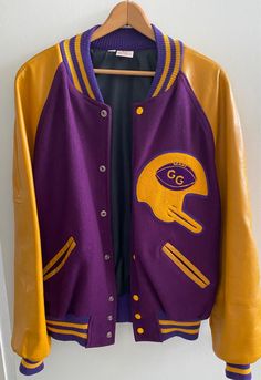 Very cool letterman custom made award jacket made by Matt's Jacket Company in Waycross, Georgia. Marked size 42. In excellent condition, no worn spots, no holes, no tears.  Looks like it has never been worn. Terrific colors, purple and almost a gold color. Lined in black. Such a well-made jacket! Vintage piece from the estate of Joe Cardella, the ARTLIFE Foundation is the culmination of the life work of artist Joe Cardella.  He was an internationally recognized artist and  a leader of the art community in Ventura, California. Cardella produced assemblage art and sculpture. Great gift! Free shipping! Winter Varsity Jacket With Baseball Collar For Fans, Purple Varsity Outerwear For College, Purple Varsity Jacket For Streetwear, Fall Varsity Jacket For Fan Gear, Varsity Fan Gear Outerwear For Fall, Fall Varsity Outerwear Fan Gear, Fall Varsity Outerwear For Fan Gear, Winter Varsity Jacket With Baseball Collar And School Spirit, Team-colored Varsity Jacket For Game Day In Fall