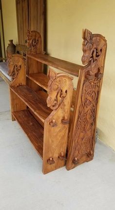 a wooden shelf with carvings on it