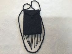 Period: before 1980's Provenance: France Execution: artisan  hand made Materials: small black beads , satin, synthetic fibre  Recycling material: yes Dimensions:  - inner deep.                       13.5 cm - 5.31" - total height                          15 cm - 5.90" - width.                                  9.5 cm - 3.74" - total cord length.               92 cm -  36.22" - total height end to end     66 cm -  25.98" Condition: don't missing beads, very good vintage condition. Delivery in good Black Handmade Beaded Necklaces For Evening, Evening Black Beaded Necklaces, Adjustable Black Beaded Necklaces For Evening, Adjustable Black Beaded Necklace For Evening, Vintage Black Beaded Necklace For Party, Black Rectangular Evening Coin Purse, Vintage Black Beaded Necklace For Gift, Vintage Black Handmade Beaded Necklaces, Adjustable Black Vintage Beaded Necklace