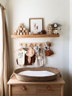 a baby's crib in the corner of a room with wooden shelves above it