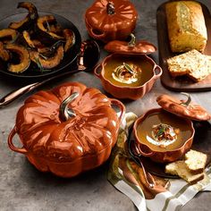 pumpkins and other foods are sitting on the table