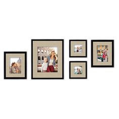 four black and white pictures hanging on the wall with one woman holding a child in her arms