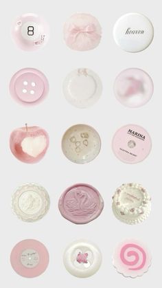 many different types of buttons on a white surface with pink and white designs around them