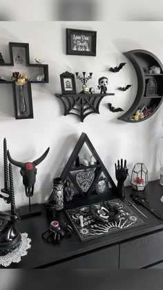 a black dresser topped with lots of halloween decorations