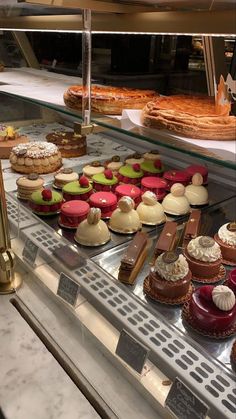 a display case filled with lots of different types of desserts