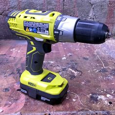 a cordless drill is sitting on the ground